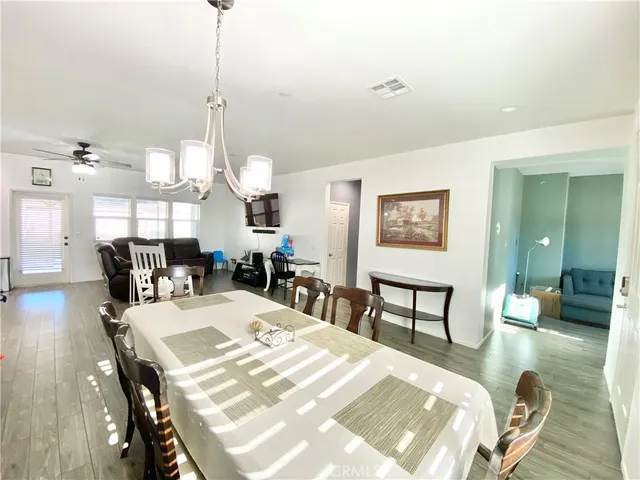 a kitchen with a table chairs refrigerator and microwave