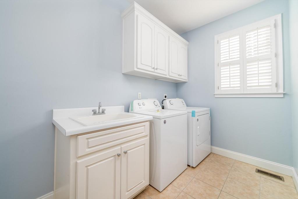 562 Grassmeade Way Snellville, GA 30078 - Photo 12 of 54 a utility room with sink dryer and washer