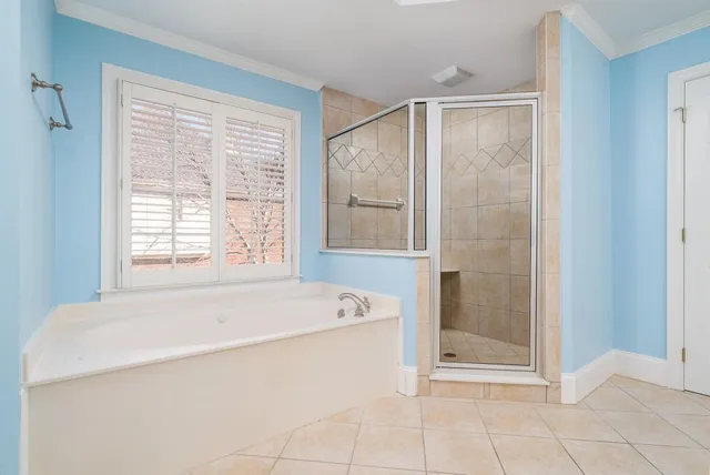a spacious bathroom with a bathtub and next to a window