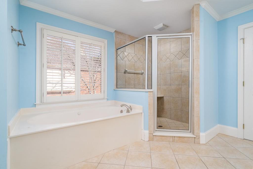 562 Grassmeade Way Snellville, GA 30078 - Photo 20 of 54 a spacious bathroom with a bathtub and next to a window