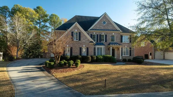a front view of a house with a yard