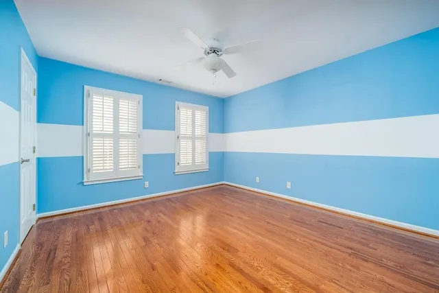 wooden floor in an empty room with a window
