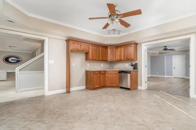 a kitchen with stainless steel appliances granite countertop a stove refrigerator and cabinets