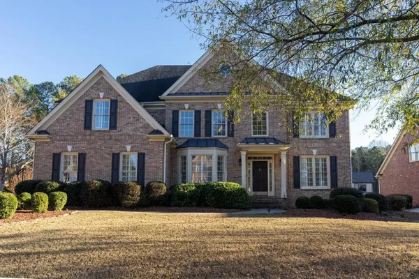 a front view of a house with a yard