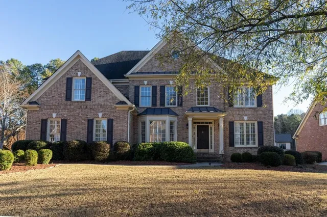 a front view of a house with a yard