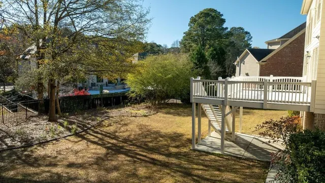 a view of a house with backyard and sitting area