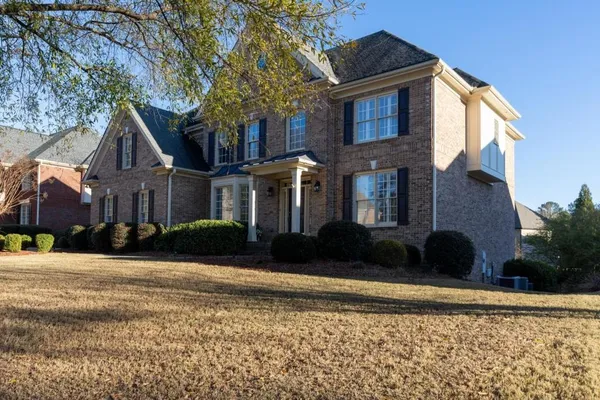 a front view of a house with a yard