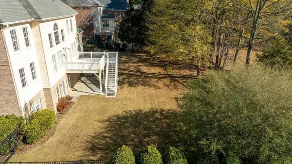 a view of residential houses with yard and staircase