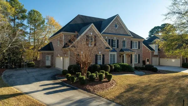 a front view of a house with a yard