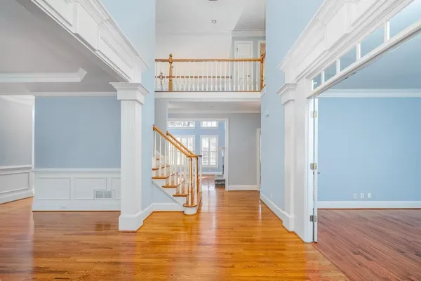 a view of entryway and hall with wooden floor