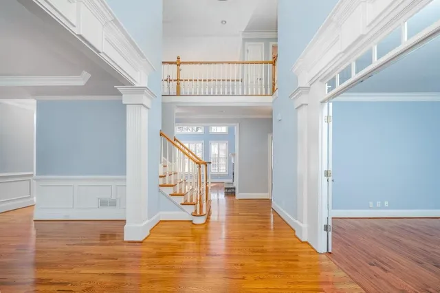 a view of entryway and hall with wooden floor