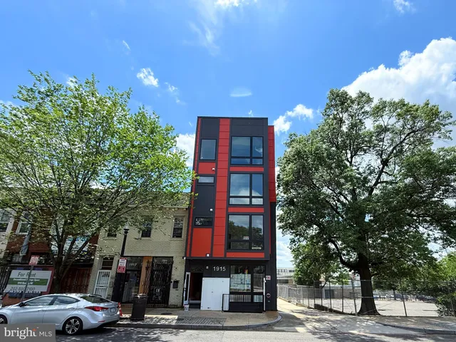a front view of a building with trees