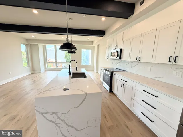 a view of a dining room with furniture a rug and wooden floor