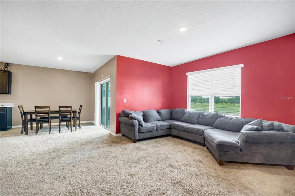180 Grove Branch Road Winter Haven, FL 33880 - Photo 17 of 49 a living room with furniture and a large window