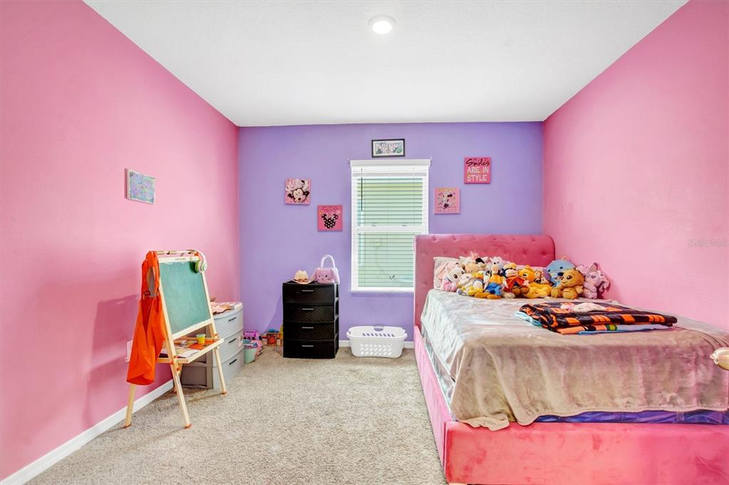 180 Grove Branch Road Winter Haven, FL 33880 - Photo 26 of 49 a bedroom with furniture and a bed