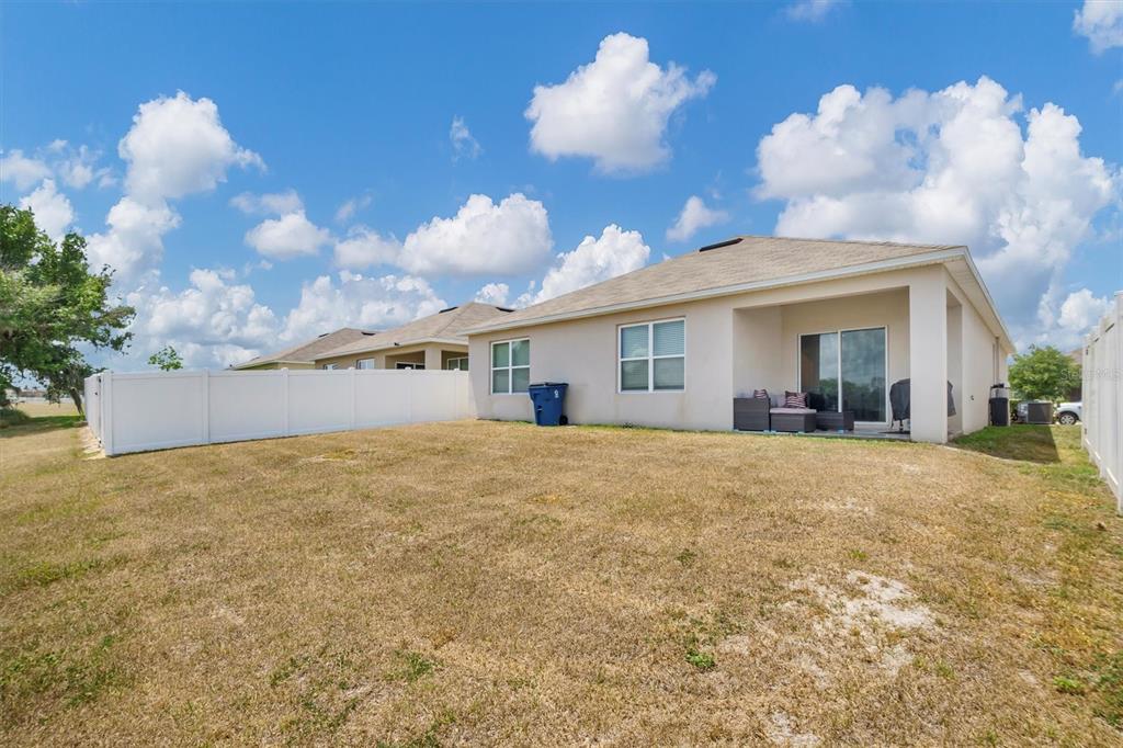 180 Grove Branch Road Winter Haven, FL 33880 - Photo 30 of 49 a view of a house with a backyard