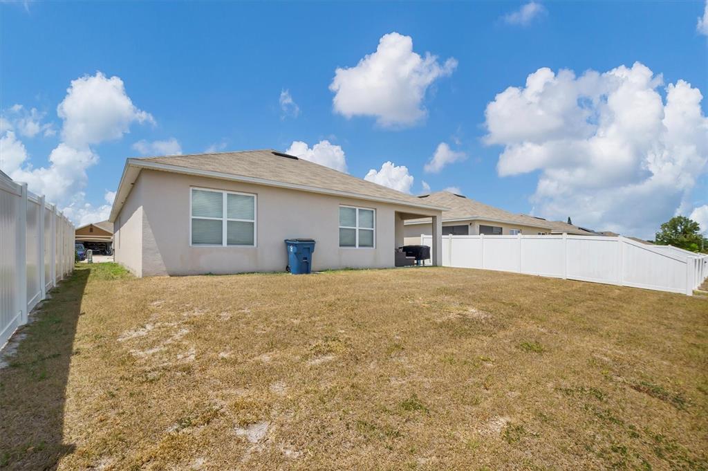 180 Grove Branch Road Winter Haven, FL 33880 - Photo 32 of 49 a view of a house with a backyard