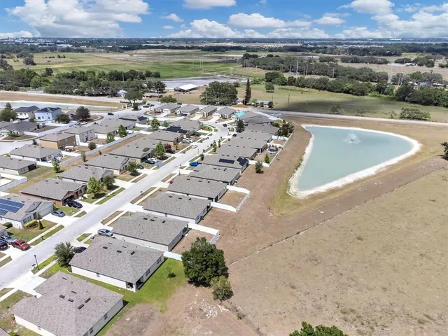 an aerial view of a house with a lake view