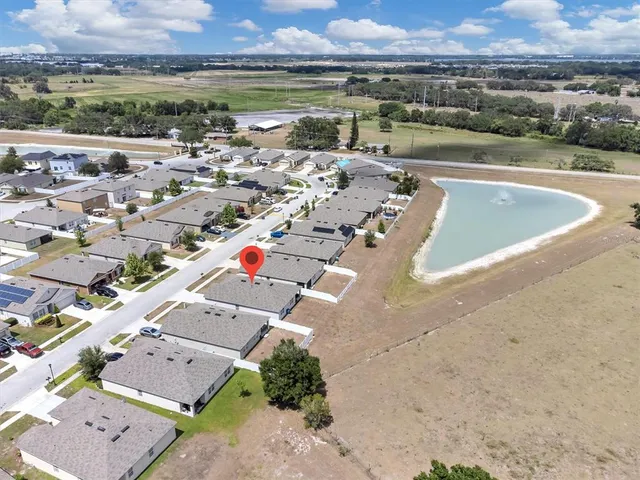 an aerial view of a house with a lake view