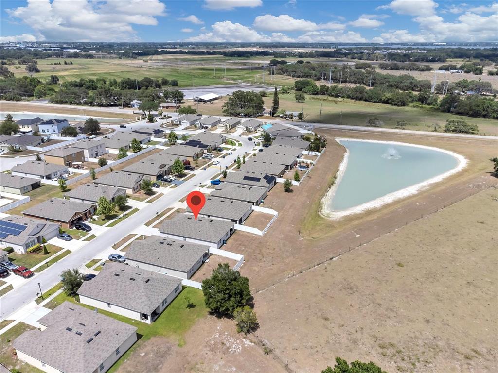 180 Grove Branch Road Winter Haven, FL 33880 - Photo 36 of 49 an aerial view of a house with a lake view