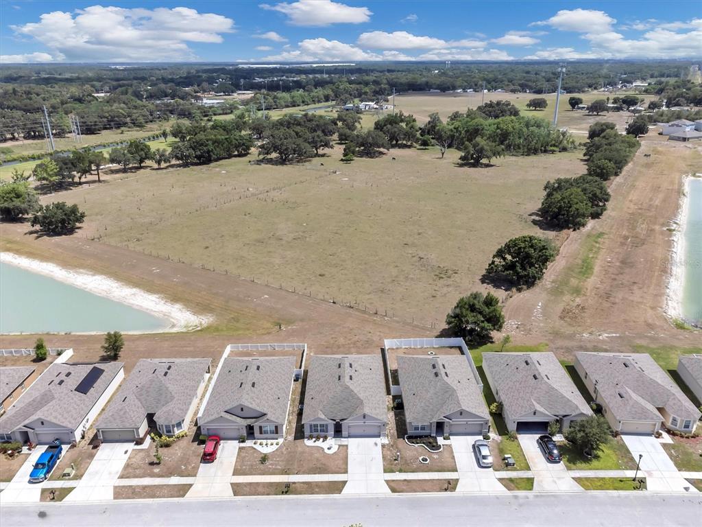 180 Grove Branch Road Winter Haven, FL 33880 - Photo 45 of 49 an aerial view of a city with lots of residential buildings and ocean view in back