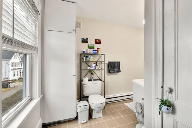 a bathroom with a toilet and a shower curtain