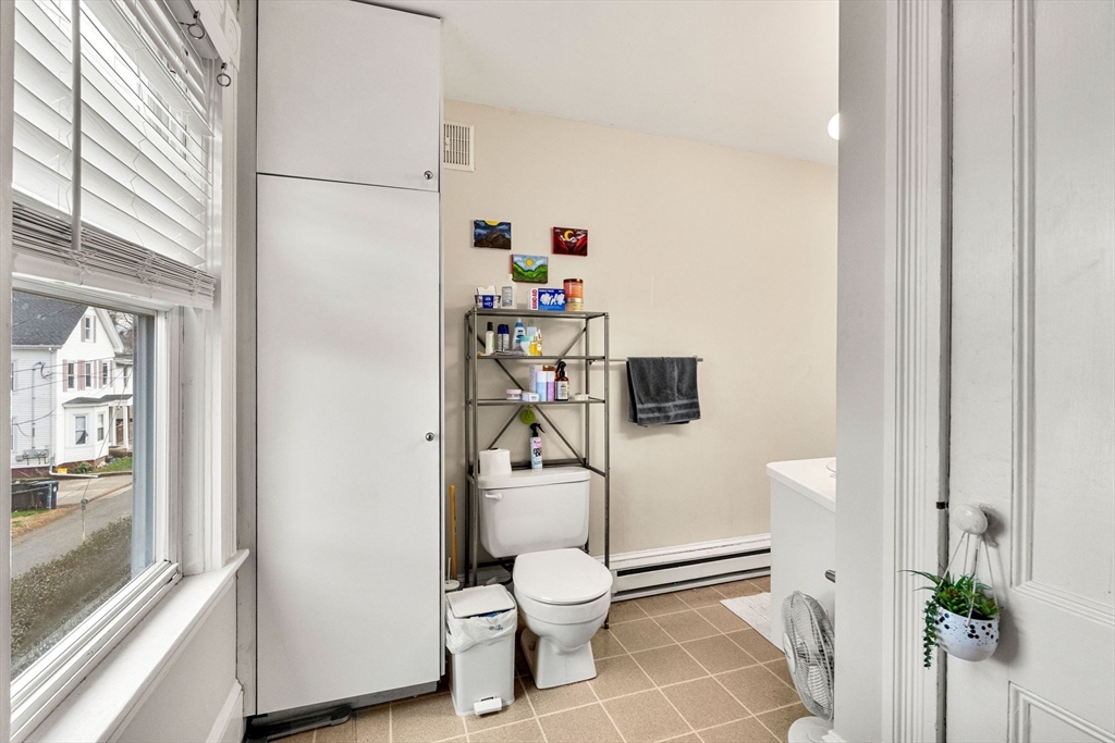 32 Kirby Street Marlborough, MA 01752 - Photo 11 of 39 a bathroom with a toilet and a shower curtain