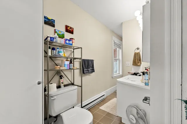 a bathroom with a sink vanity mirror and toilet