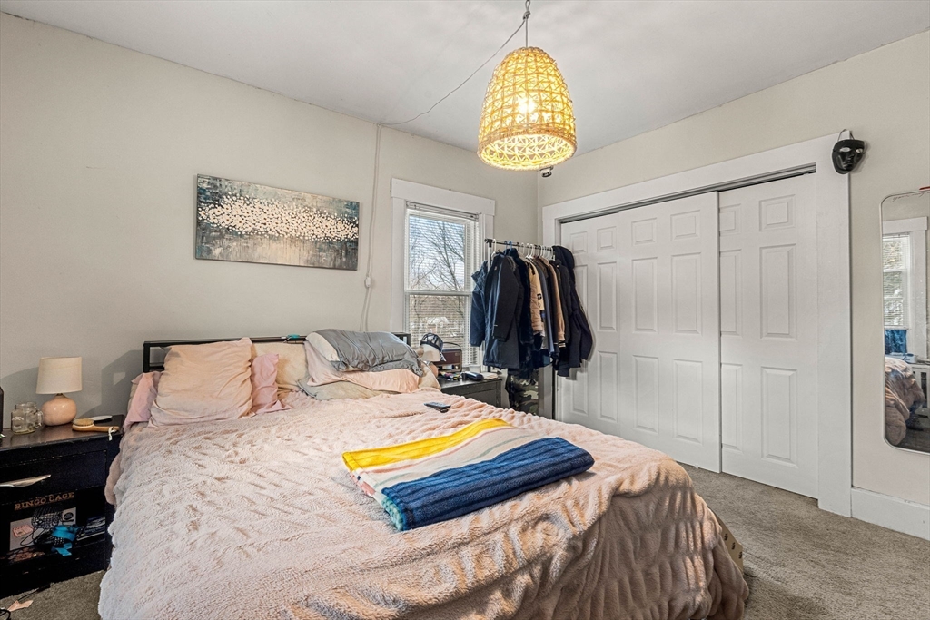 32 Kirby Street Marlborough, MA 01752 - Photo 19 of 39 a bedroom with a bed and a chandelier