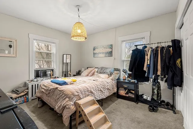 a bedroom with a bed and a tv