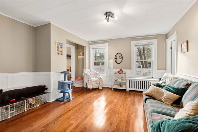 a living room with furniture and wooden floor