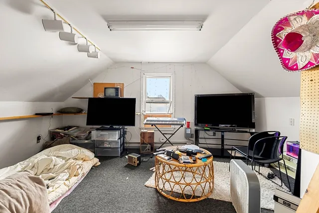 a bedroom with bed and a flat screen tv