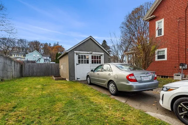 a white house covered with tall trees