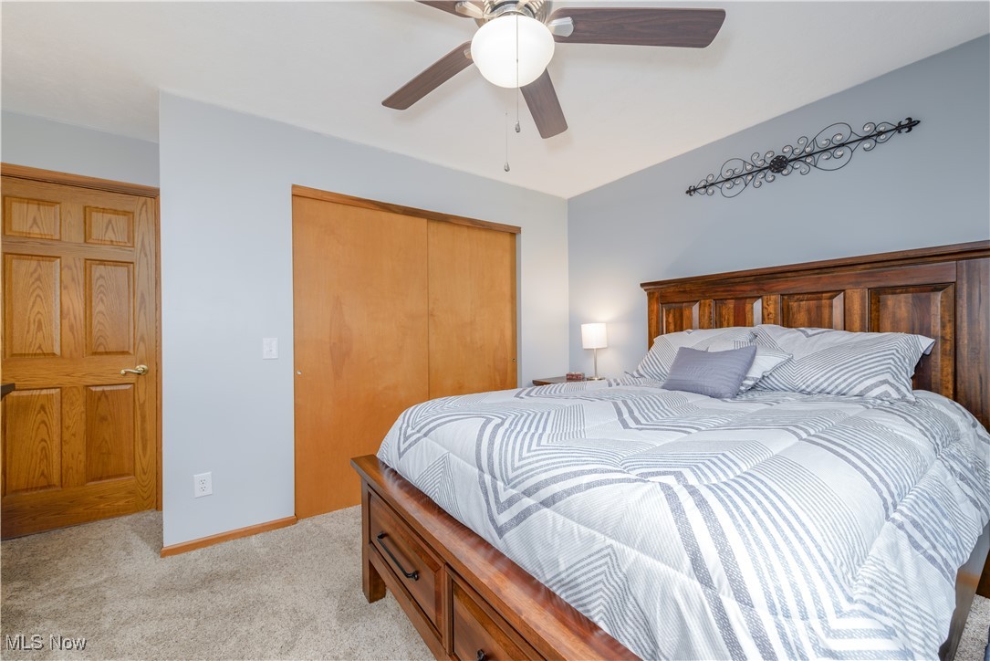 1435 Industry Road Atwater, OH 44201 - Photo 21 of 48 Carpeted bedroom with ceiling fan and a closet