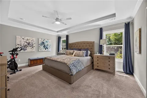 a bed room with a bed and a large window
