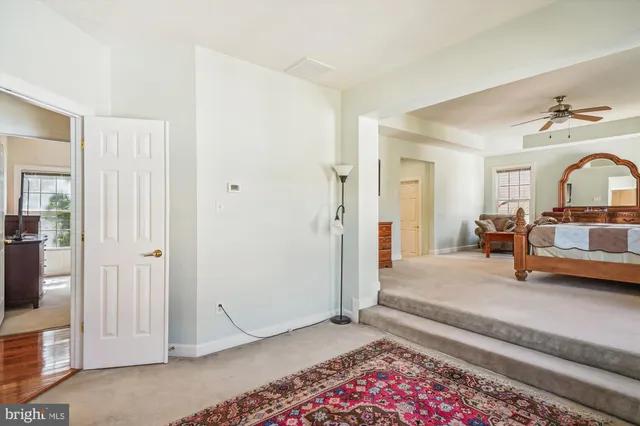 a bedroom with a dresser and a flat screen tv