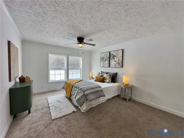 a living room with furniture a ceiling fan and a rug