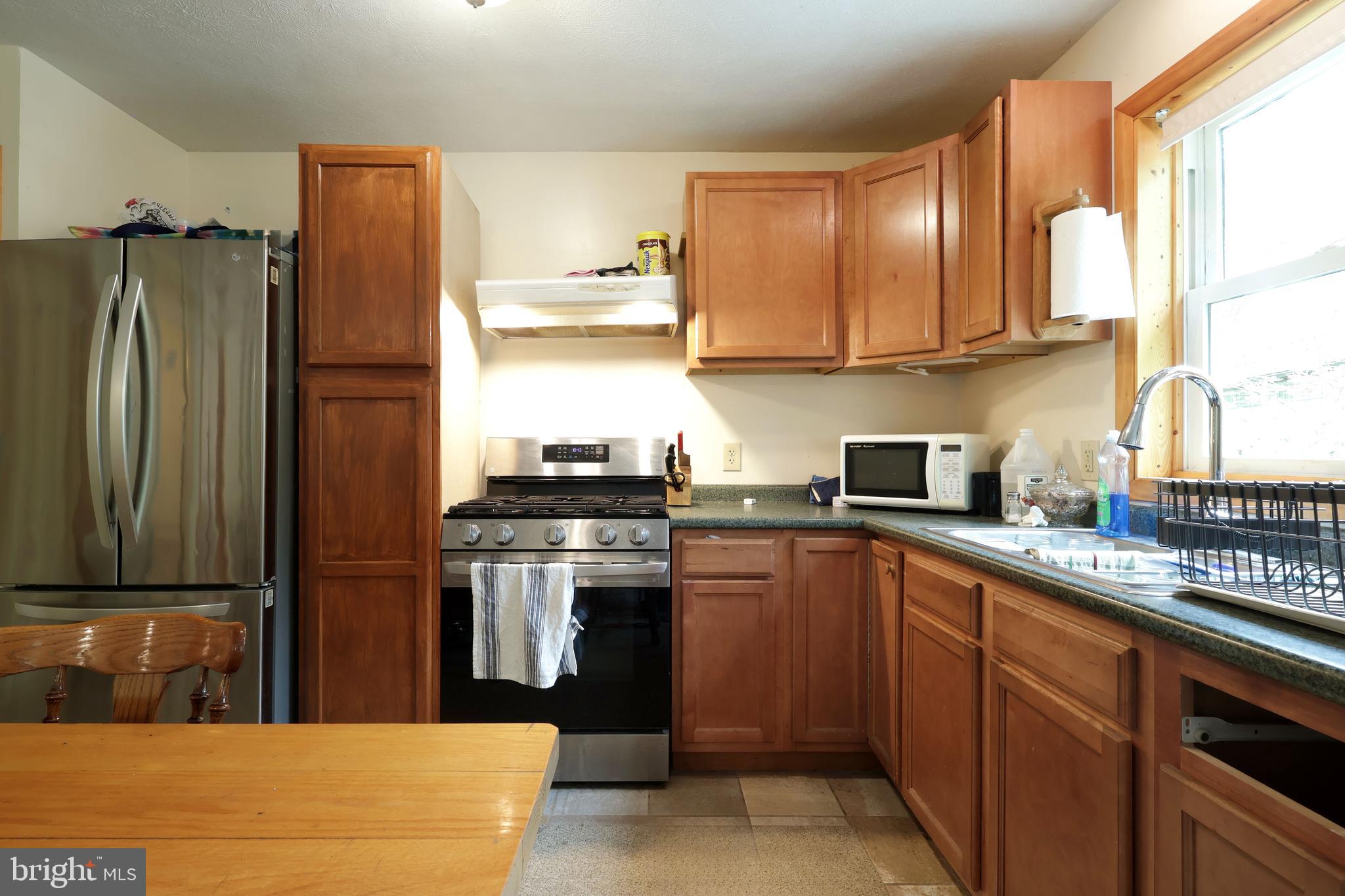 358 Buckridge Road Howard, PA 16841 - Photo 14 of 40 a kitchen with stainless steel appliances granite countertop a refrigerator and a sink
