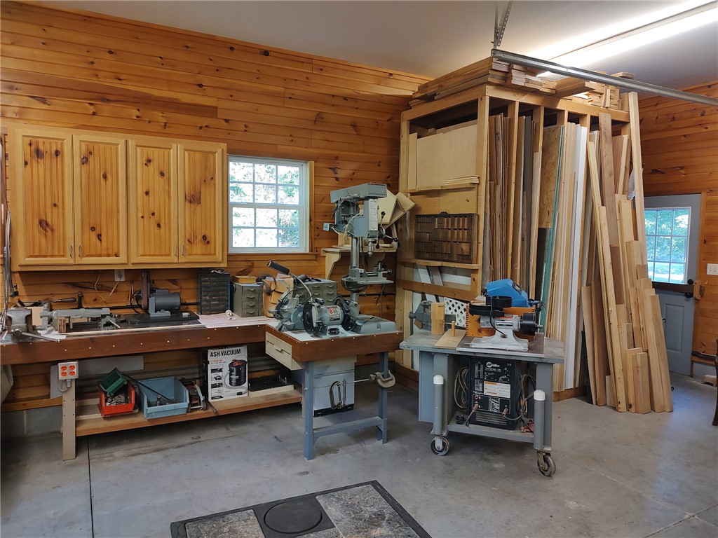 160 Sentell Road Williamston, SC 29697 - Photo 41 of 45 A well-equipped workshop, featuring ample wooden paneling and practical workbenches, awaits creative endeavors.