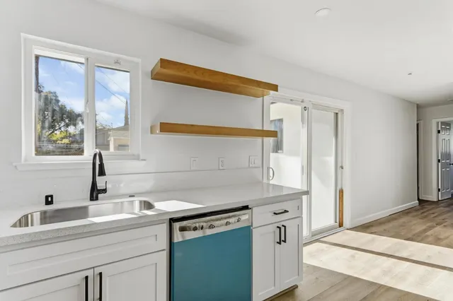 a kitchen with a sink cabinets and a window