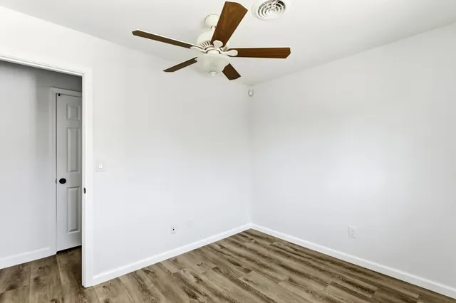 a view of a room with wooden floor
