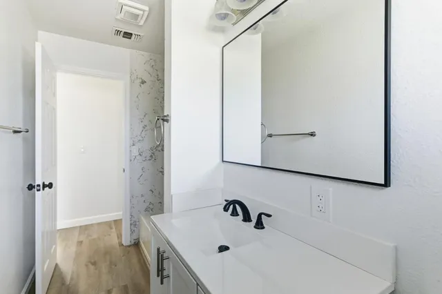 a bathroom with a sink and a mirror