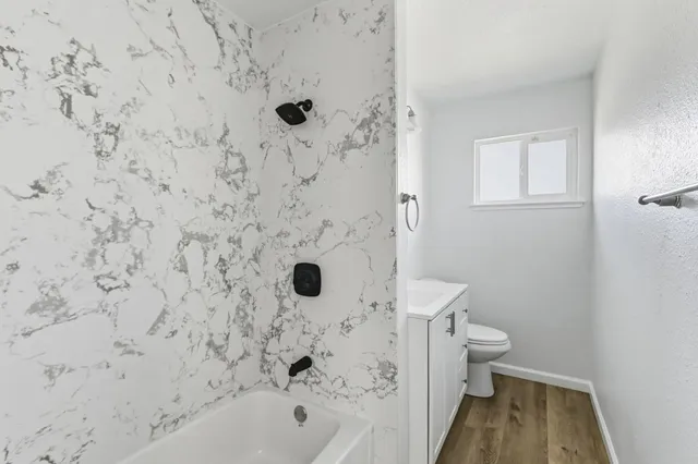 a bathroom with a bathtub and a toilet