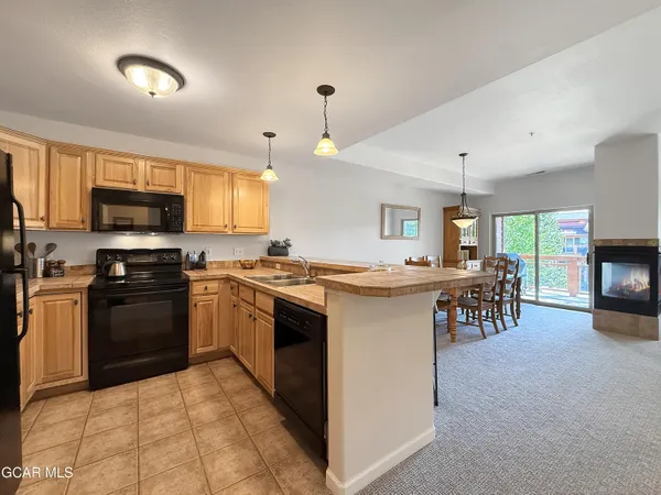 a kitchen with a sink stove and oven