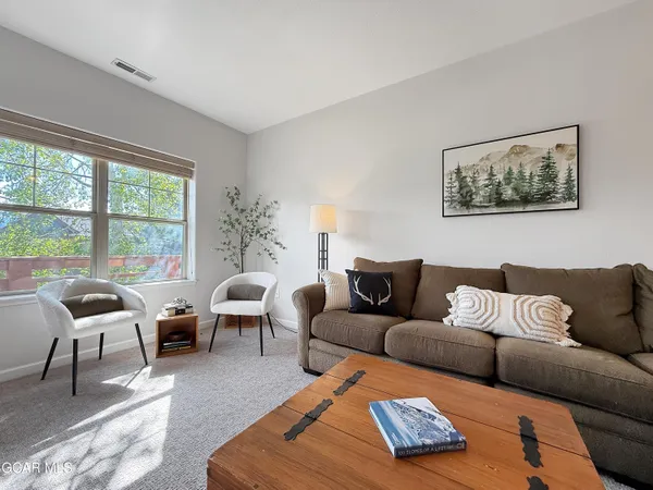 a living room with furniture and a large window