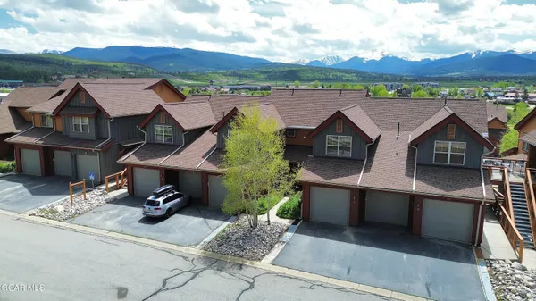 an aerial view of a house with swimming pool and mountain view