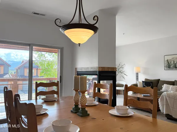 a view of a livingroom with furniture and a floor to ceiling window