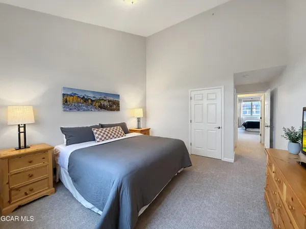 a bedroom with a bed and a lamp