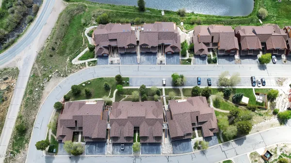 an aerial view of multiple houses with yard