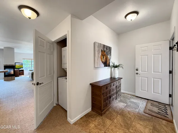 a view of a hallway to room with furniture